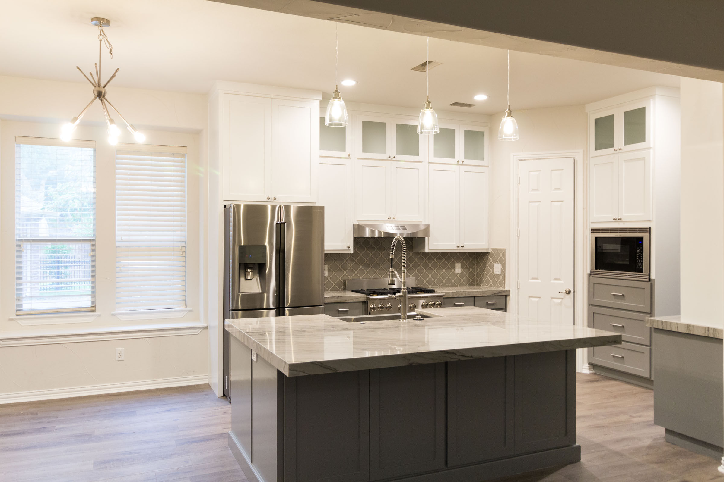 White angle picture of Contemporary kitchen remodel, grey and white, shaker cabinets, stainless steel, farmhouse sink, open floor plan