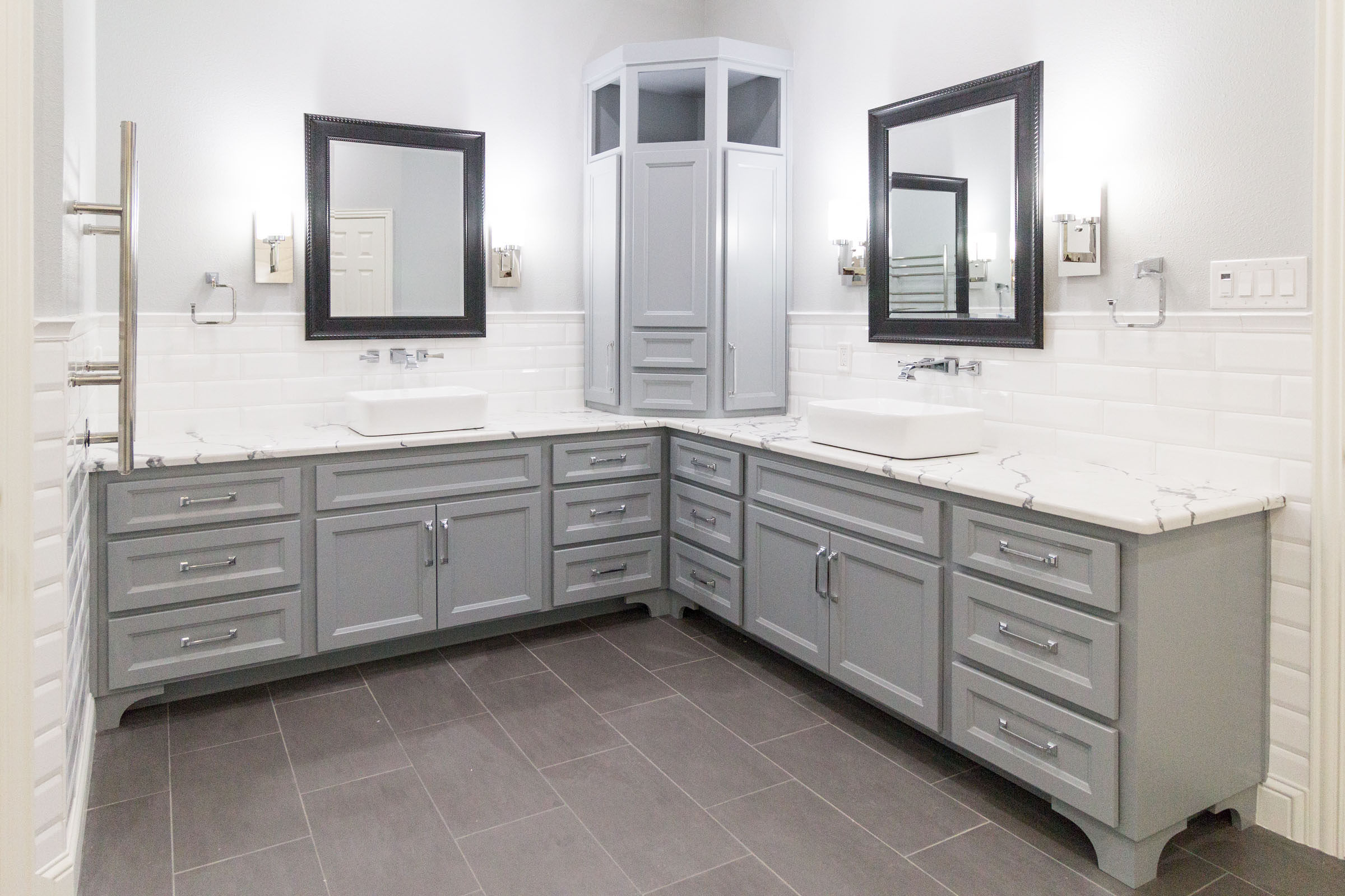 Contemporary styled bathroom remodel, grey shaker cabinets, white marble counters, dark grey trimmed vanity mirrors, jack and jill, white backsplash, grey paint