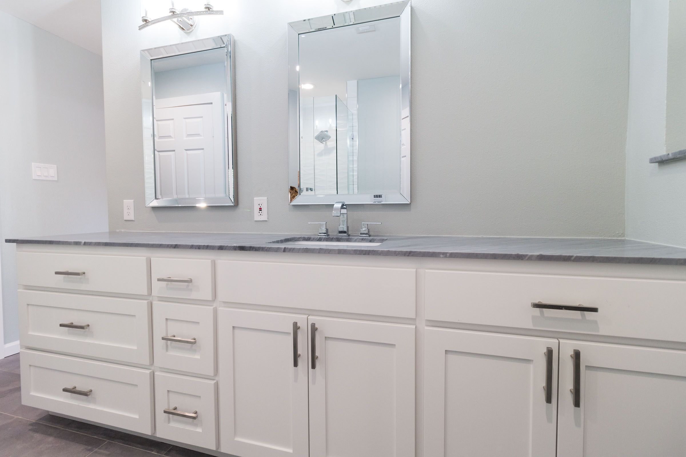 White shaker bathroom cabinets, grey granite, chrome accents