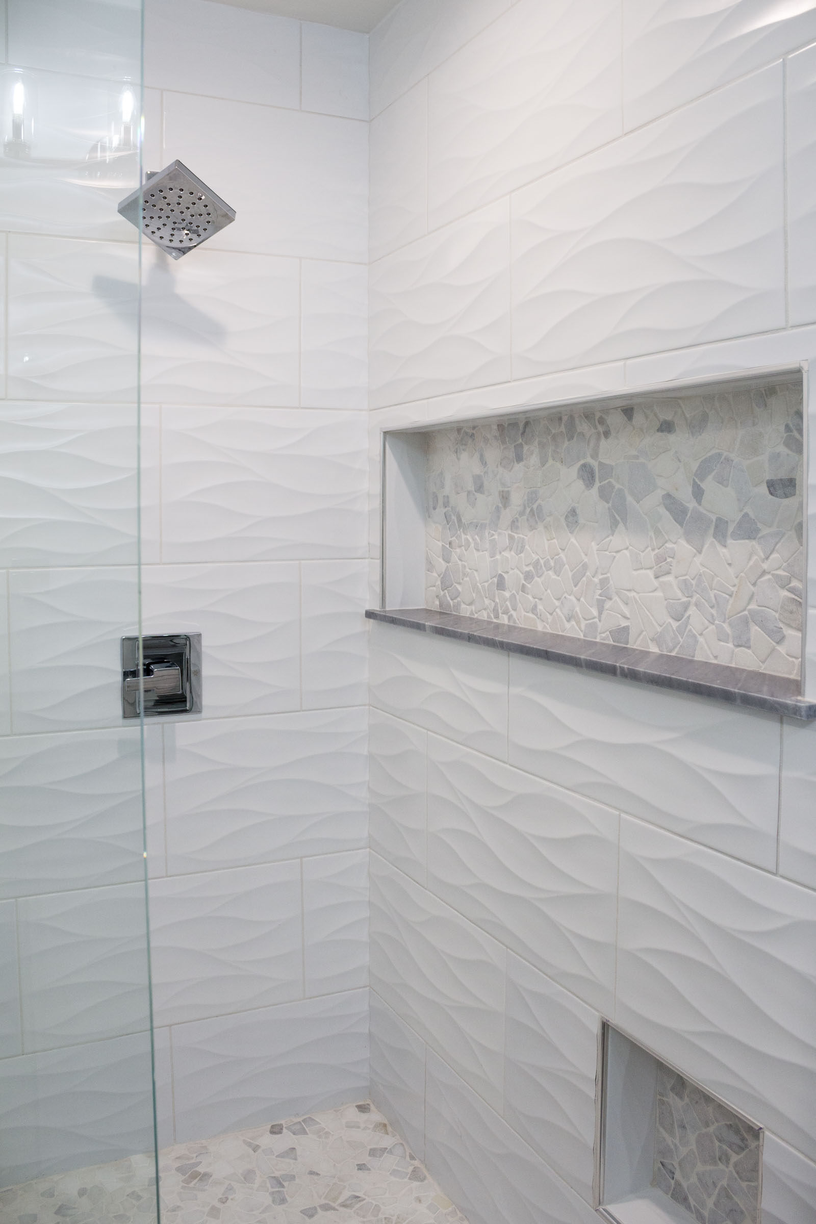 Walk in shower remodel with white tile and niche inserts