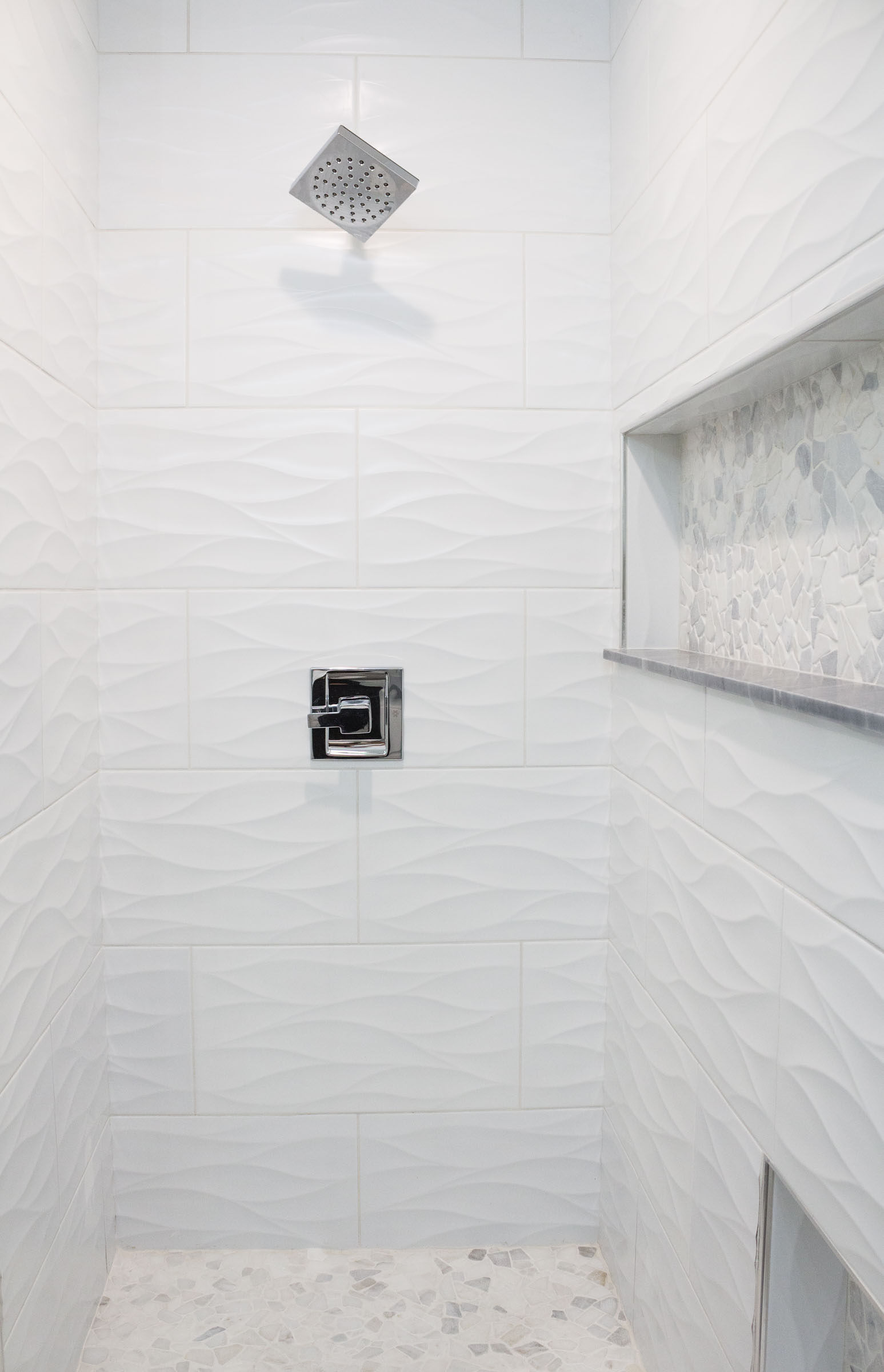 White walk in shower remodel with tile variety and stainless steel hardware