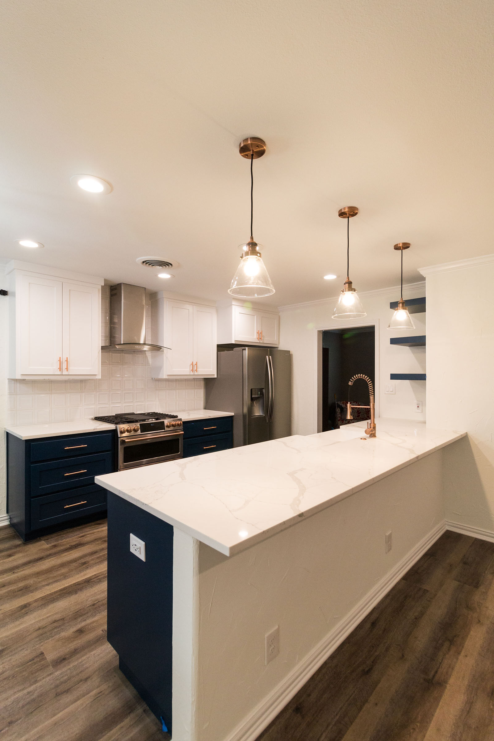 Open concept navy and copper kitchen remodel