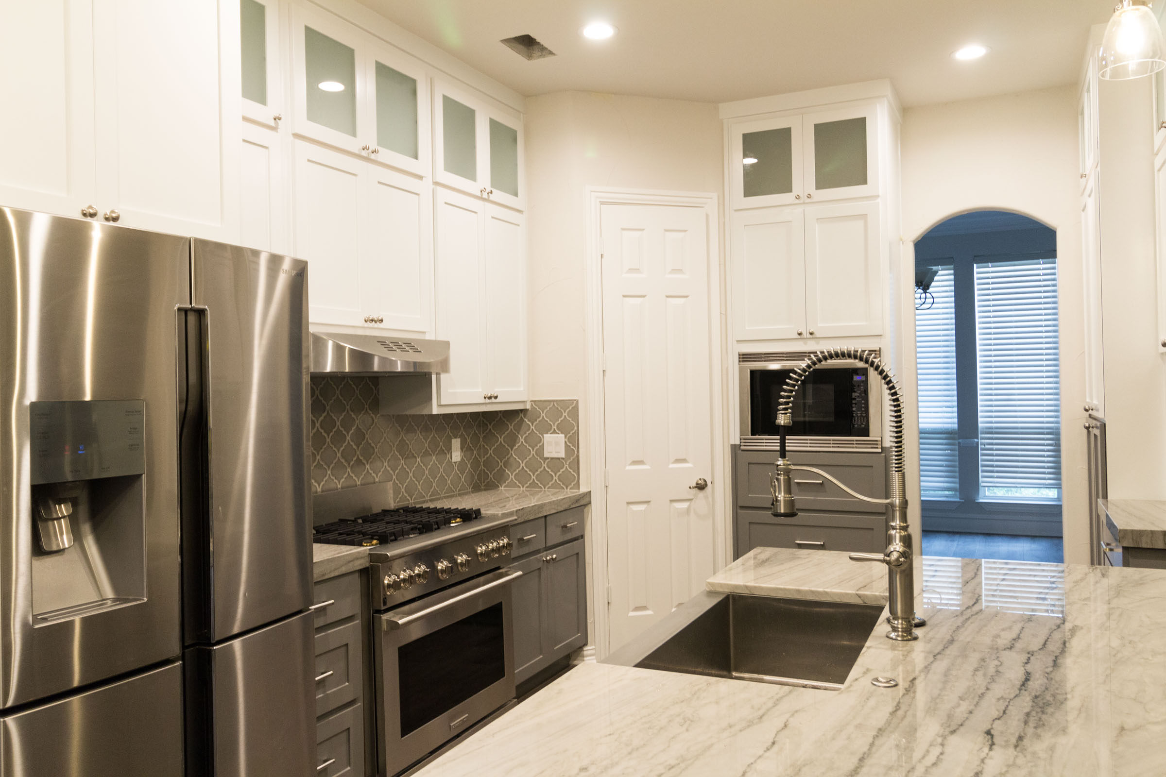 Contemporary kitchen remodel, grey and white, shaker cabinets, stainless steel, farmhouse sink, open floor plan