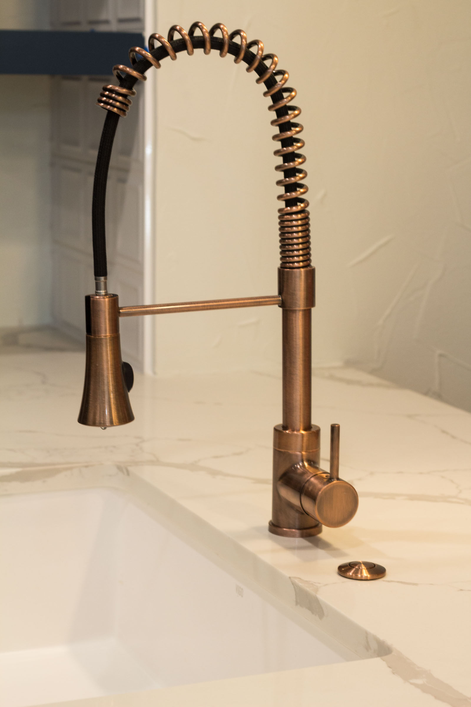 Close up photo of copper swan neck sink faucet
